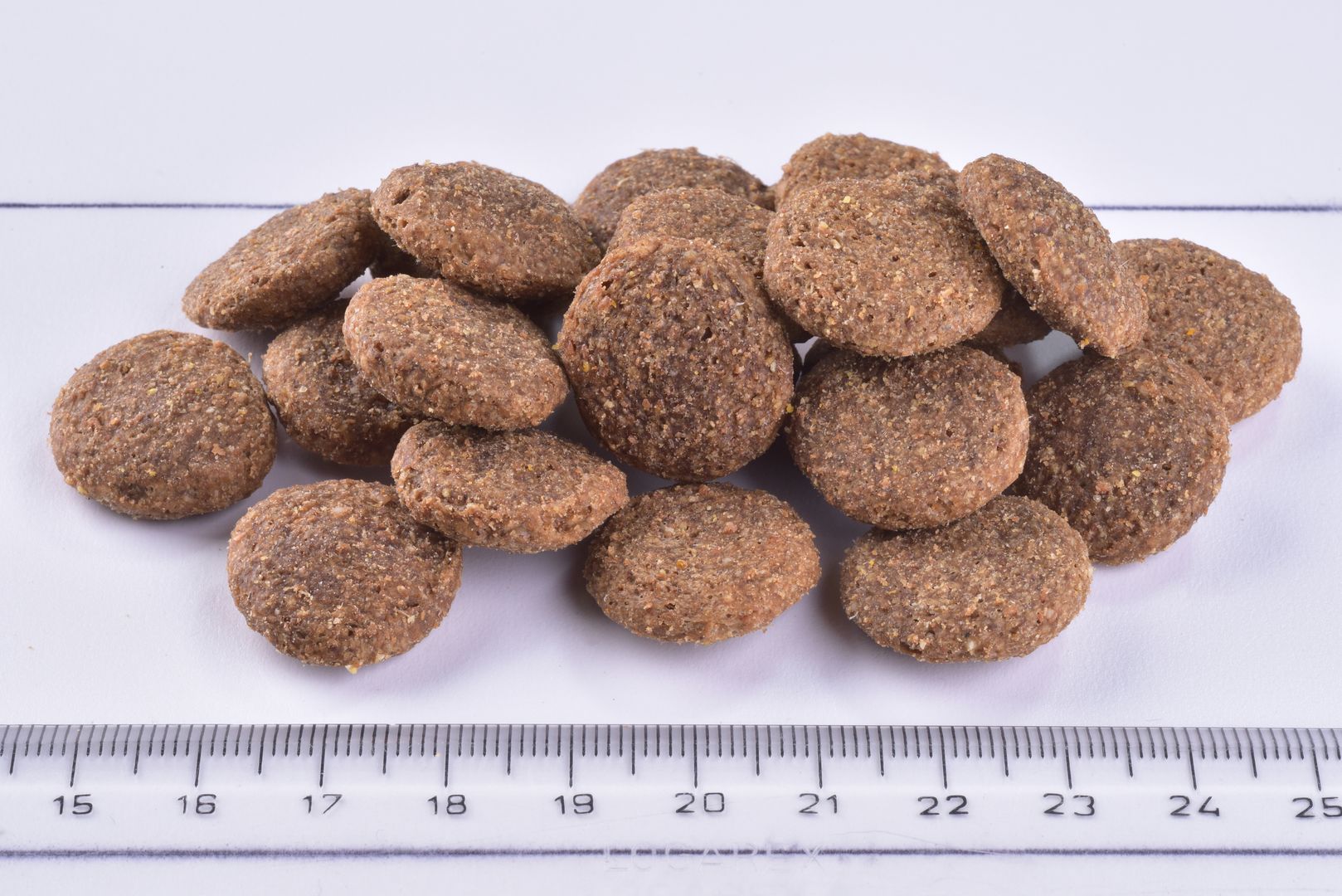 Brit Premium Dog Dry Food Senior Large & XLarge Kibble on a white background with a ruler for scale.